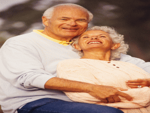 an elderly man and woman hugging