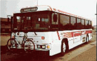 image of public bus with bike attached to front rack